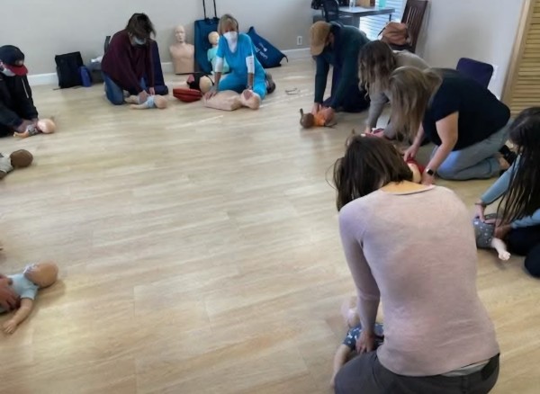 Students practicing CPR techniques in a group class