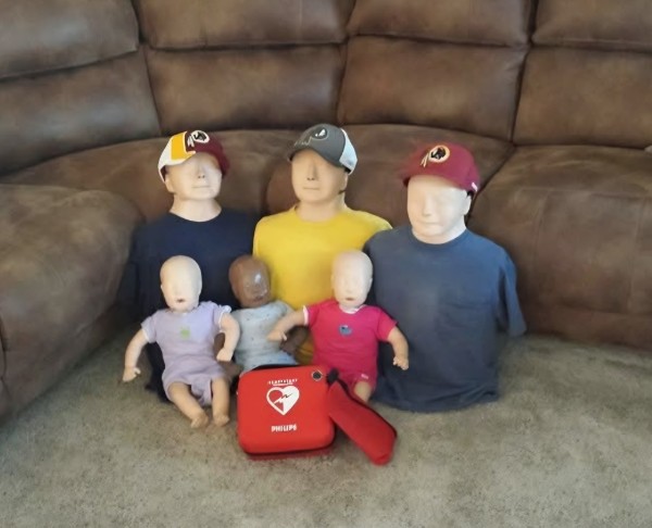 Adult and infant CPR training mannequins with AED trainer